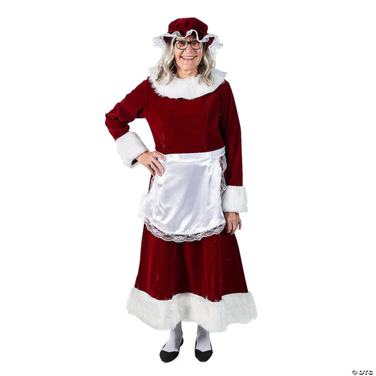 Woman in a burgundy velvet Mrs. Claus dress with white fur trim, lace-trimmed satin apron and mop hat