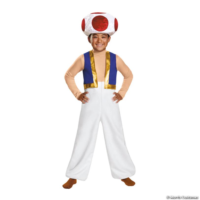 Boy wearing the Toad costume: red-spotted mushroom cap and white jumpsuit with blue vest, front view