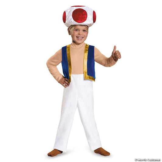 Toddler wearing the Toad costume: red-spotted mushroom cap, white jumpsuit and blue vest, giving a thumbs up