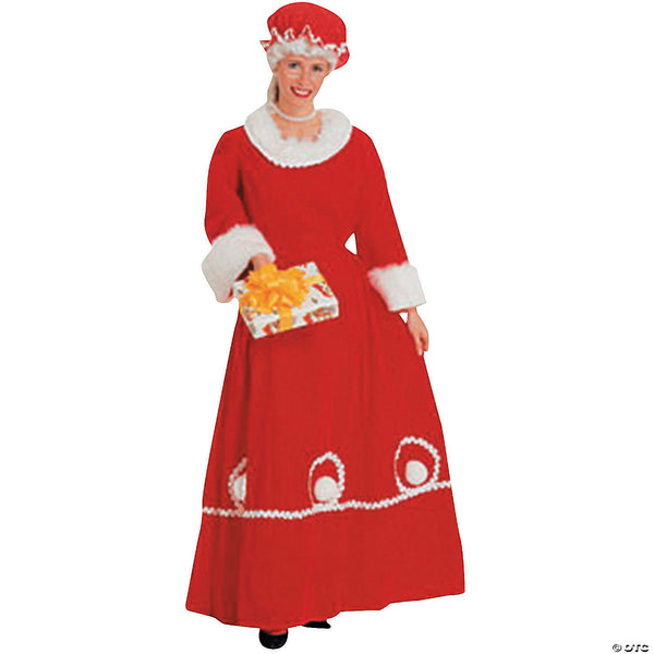 Woman wearing a long red velvet Mrs. Claus dress with white fur trim and mob cap
